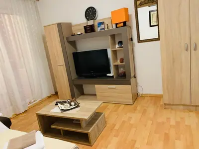 a living room with a tv and a coffee table at Apartment Oleander in Budva