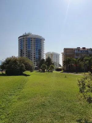 a large park with a large building in the background at Apartment Oleander in Budva