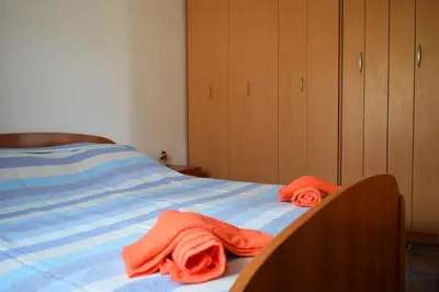 a bedroom with a bed with two towels on it at Apartment Sunny in Bar
