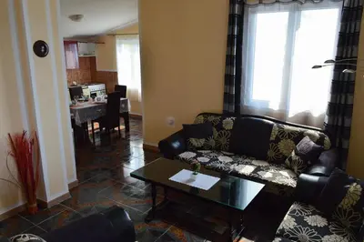 a living room with a couch and a table at Apartment Sunny in Bar