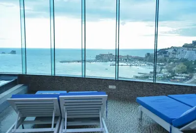 a room with chairs and a view of the ocean at Luxury Apartments Tre Canne Can in Budva