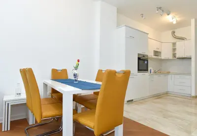 a kitchen and dining room with a table and chairs at Luxury Apartments Tre Canne Can in Budva