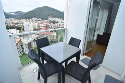 a table and chairs on a balcony with a view at Luxury Apartments Tre Canne Can in Budva