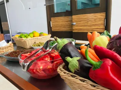 a table with baskets of fruits and vegetables on it at Hotel Aleksandar in Budva