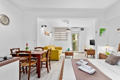 a living room with a bed and a dining room at Apartments Casa Mia in Kotor