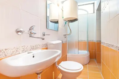 a bathroom with a sink and a toilet at Apartments Casa Mia in Kotor