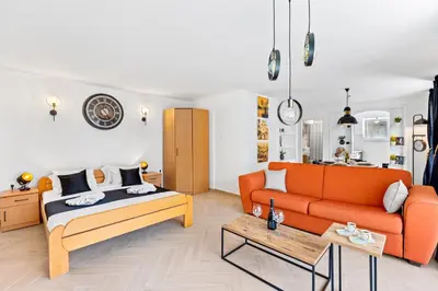 a living room with a bed and a couch at Apartments Casa Mia in Kotor