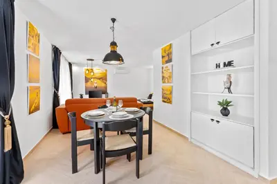 a living room with a table and a couch at Apartments Casa Mia in Kotor