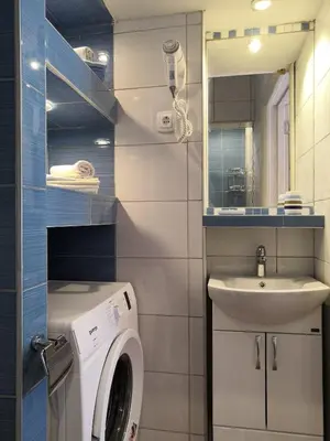 a bathroom with a washing machine and a sink at Apartments Maris Garden in Petrovac na Moru