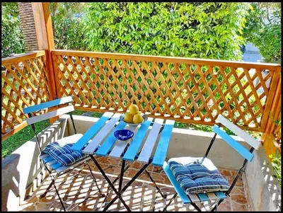 a blue table and two chairs on a porch at Apartments Maris Garden in Petrovac na Moru