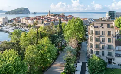 a view of a city with trees and buildings at Hotel Majestic in Budva