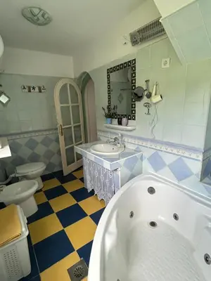 a bathroom with a tub and a sink and a toilet at Lake house Puro in Dodoši