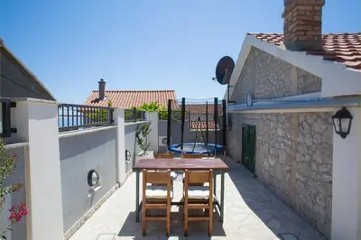 a patio with a table and chairs on a balcony at Holiday home Kristina in Krimovice