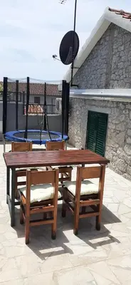 a wooden table with two chairs and a ping at Holiday home Kristina in Krimovice
