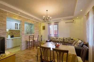 a living room with a dining table and a kitchen at Holiday home Kristina in Krimovice