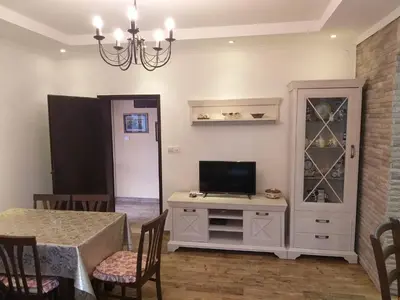 a dining room with a tv and a table with chairs at Holiday home Kristina in Krimovice