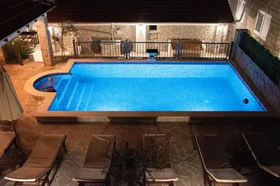 a large swimming pool with chairs around it at Holiday home Kristina in Krimovice