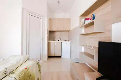 a small apartment with a kitchen and a living room at Apartments Vukmarković in Sutomore