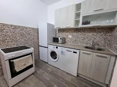 a kitchen with a sink and a washing machine at Apartments Vukmarković in Sutomore