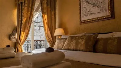 a hotel room with a bed and a window at Historic Boutique Hotel Cattaro in Kotor