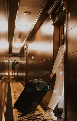 a person pulling a suitcase in a train at Historic Boutique Hotel Cattaro in Kotor