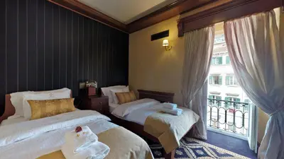 a hotel room with two beds and a balcony at Historic Boutique Hotel Cattaro in Kotor