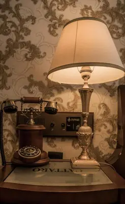 a lamp sitting on a table with a wall at Historic Boutique Hotel Cattaro in Kotor