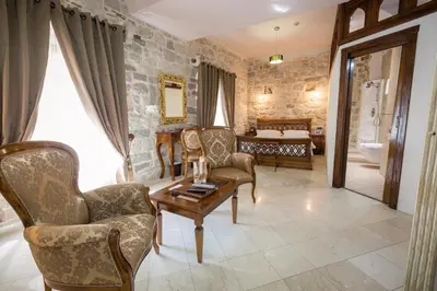 a living room with chairs and a table at Hotel Villa Duomo in Kotor