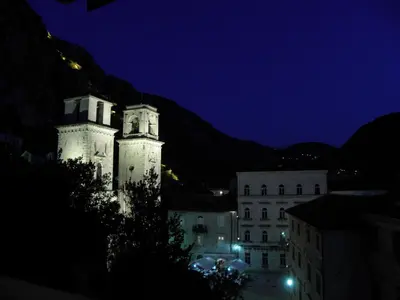 a building with two towers at night at Hotel Villa Duomo in Kotor