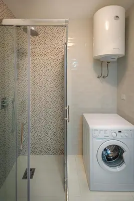 a bathroom with a washing machine and a shower at Adriatic Sunshine Apartment in Budva