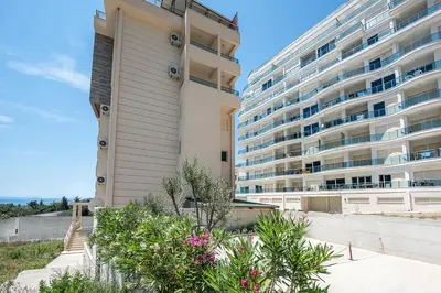 a large apartment building next to a large building at Adriatic Sunshine Apartment in Budva