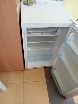 an empty refrigerator with its door open in a kitchen at Vila Branka in Čanj