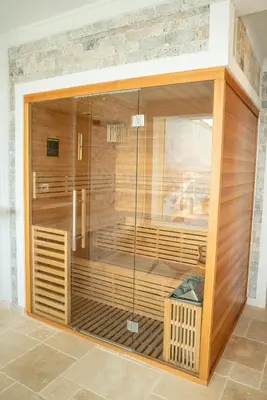 a sauna with a glass wall in a room at Hotel Freiburg in Ulcinj
