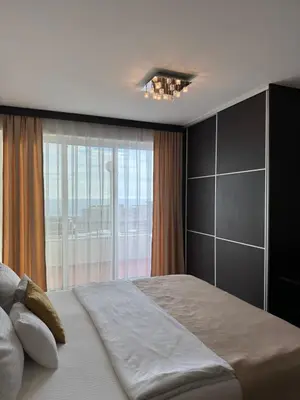 a bedroom with a large bed with a large window at Hotel Freiburg in Ulcinj
