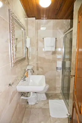 a bathroom with a sink and a shower at Hotel Marija in Kotor