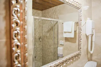a bathroom with a mirror and a shower at Hotel Marija in Kotor