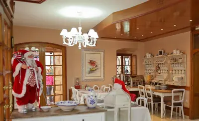a room with santa claus standing in a dining room at Hotel Marija in Kotor
