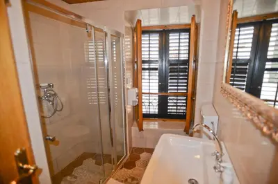 a bathroom with a shower and a toilet and a sink at Hotel Marija in Kotor