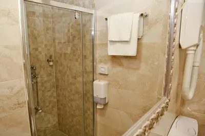 a bathroom with a shower and a toilet at Hotel Marija in Kotor