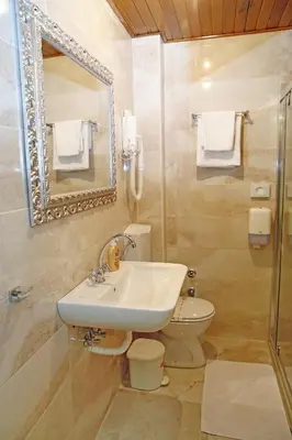a bathroom with a sink and a toilet and a mirror at Hotel Marija in Kotor