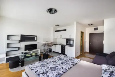 a living room with a bed and a couch at Zebra in Podgorica