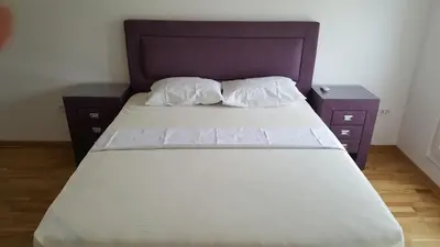 a bed with two nightstands next to a bed sidx sidx sidx at Zebra in Podgorica