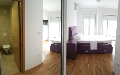 a bedroom with a bed and a mirror at Zebra in Podgorica
