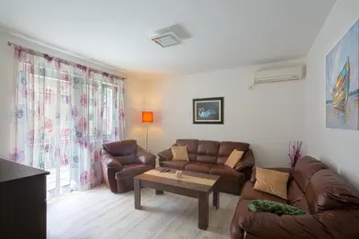 a living room with a couch and a coffee table at Apartman Aleksandra in Budva