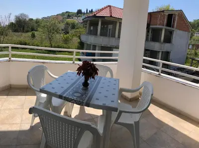 a blue table and chairs on a balcony at Guest House Green Garden in Ulcinj