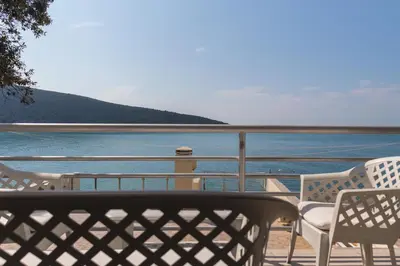a balcony with chairs and a view of the water at Seaside Apartment Kruce in Kruče
