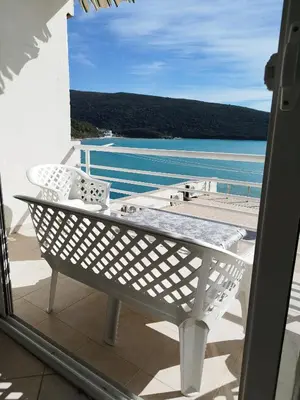 a balcony with a table and a view of the water at Seaside Apartment Kruce in Kruče