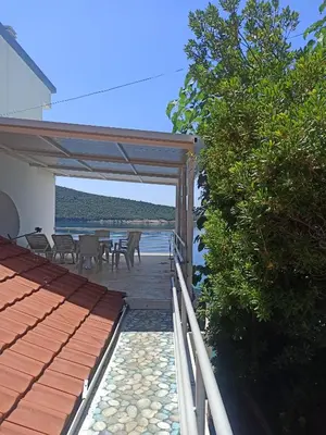 a patio with a view of the ocean from a house at Seaside Apartment Kruce in Kruče