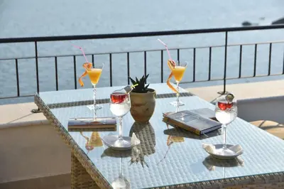 a table with four wine glasses on a balcony at Hotel Pirate Old Town in Ulcinj