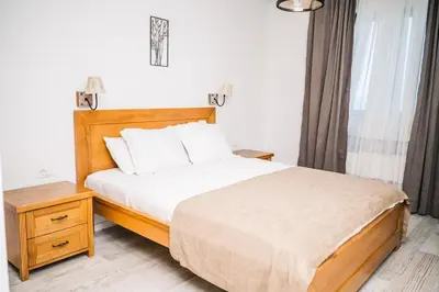 a bedroom with a bed with white sheets and white pillows at Hotel Pirate Old Town in Ulcinj